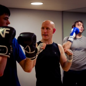 Coach Phil Whyte gives pointer on technique to student 